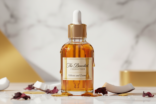 body oil in a dropper bottle with the fragrance of Hibiscus and Coconut with the oil dripping down the bottle and the company name on the bottle The Benedict Collection