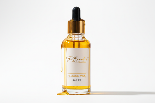 dropper bottle body oil with oil dripping down the bottle with the company name on the bottle The Benedict Collection with the fragrance Almond Milk